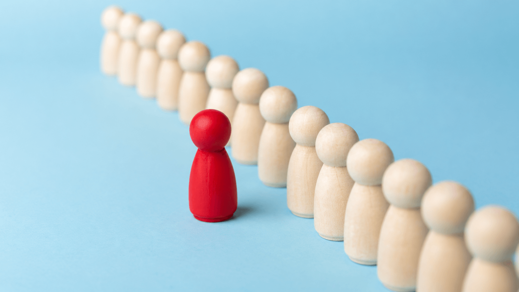 Abstract banner showing a red wooden figure standing apart from a row of natural wooden figures on a blue background, symbolizing AI-powered lead prioritization and customer scoring.
